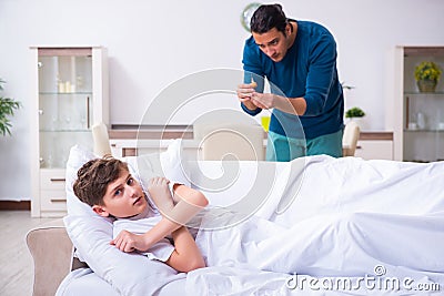 Young father caring for sick son Stock Photo