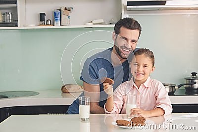 Young father and daughter having a snack meal Stock Photo