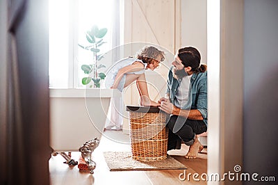 Young father painting small daugter`s nails in a bathroom at home. Stock Photo