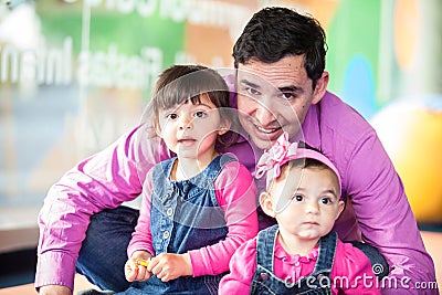 Young father playing with his daughters. Early stimulation for toddlers concept Stock Photo