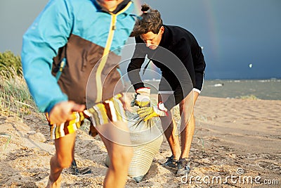 Young father with son on beach digging pit under the rainbow, playing, looking for treasure, lifestyle happy family on Stock Photo