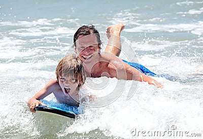 Young father and son learning to surf Stock Photo