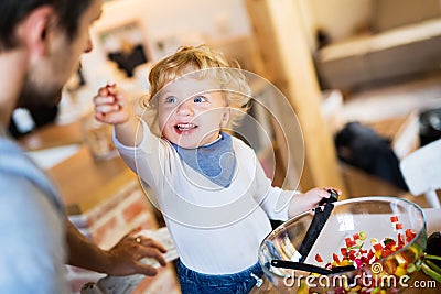 Young father with a toddler boy cooking. Stock Photo