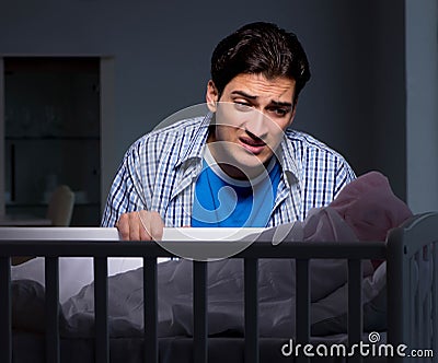 Young father under stress due to baby crying at night Stock Photo