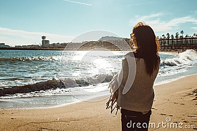 Young female adult standing in the sun next to the sea Editorial Stock Photo