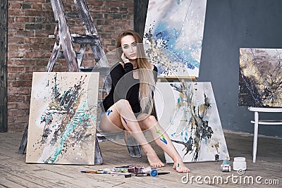 Young female artist painting abstract picture in studio, beautiful woman portrait Stock Photo