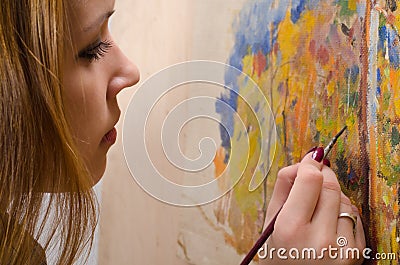 Young female artist painting landscape Stock Photo