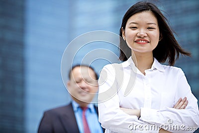 Young female Asian executive and senior Asian businessman smiling portrait Stock Photo