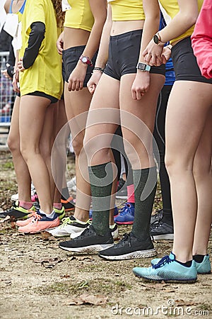 Young female atheletes ready to run. Start line. Athleticism Stock Photo