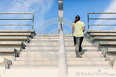 Young female athlete doing run up at local stadium Editorial Stock Photo