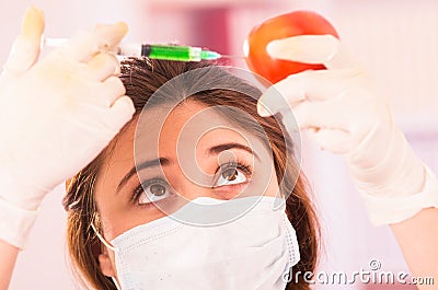 Young female biologist injecting syringe Stock Photo