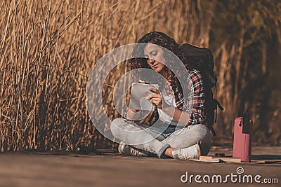 Female biologist writing in notebook during field work Stock Photo