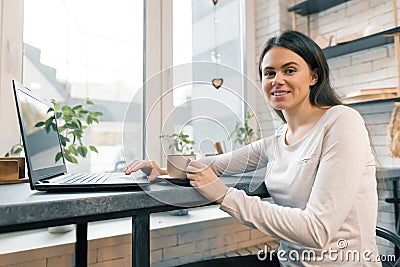 Young female blogger in coffee shop with laptop computer Stock Photo