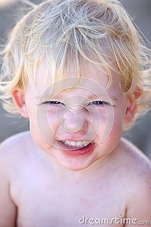 Young female child or toddler with cheeky grin on her face Stock Photo