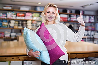 Young female customer boasting purchased home textiles Stock Photo