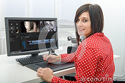 Young female designer using graphics tablet for video editing Stock Photo