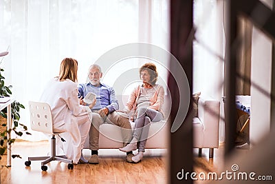 Female doctor checking blood pressure of senior man. Stock Photo