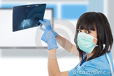 Young female doctor looking at patients x-ray Stock Photo