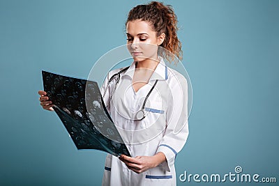 Young female doctor looking at roentgenogram Stock Photo