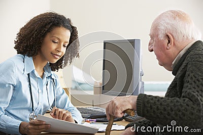 Young female Doctor with senior male patient Stock Photo