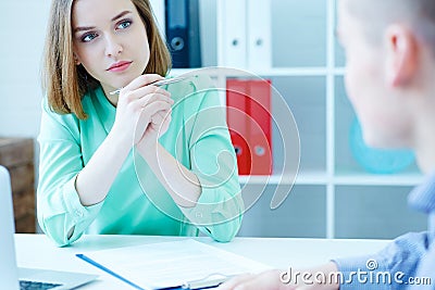 Young female employee of the staffing agency listening attentively the male job seeker. Business, office, law and legal Stock Photo