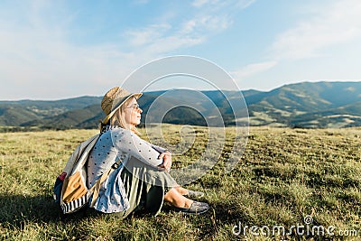 Young female enjoying the sunset in the mountains Stock Photo