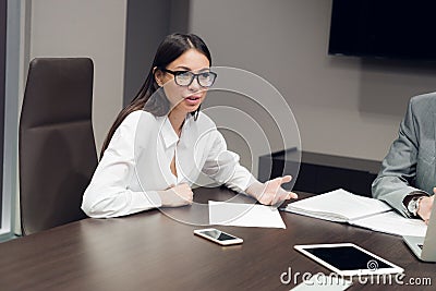 Young female executive smiling during meeting in office conference room Stock Photo