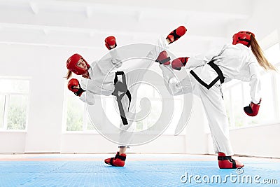 Young female fighter boxing using karate technique. Stock Photo