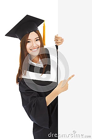 Young female graduation students point to blank board Stock Photo