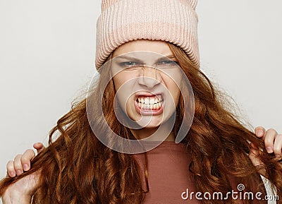 Young female grimacing and making angry gesture. Negative human emotions, feelings and reaction. Stock Photo