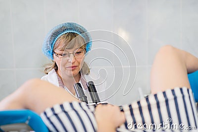 Young Female Gynecologist During Examination In Her Office Stock Photo