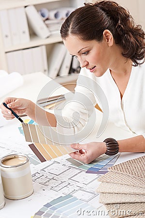 Young female interior designer working at office Stock Photo