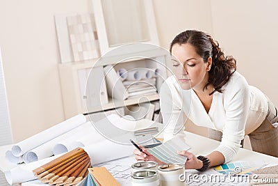 Young female interior designer working at office Stock Photo