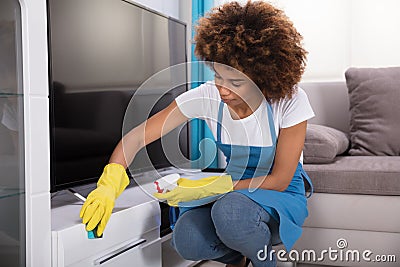 Janitor Cleaning Furniture With Sponge Stock Photo