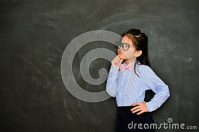 Young female little teacher looking at empty area Stock Photo