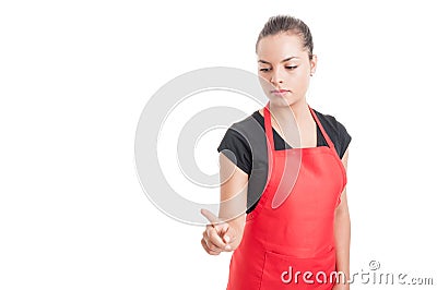 Young female market employee pointing something down Stock Photo