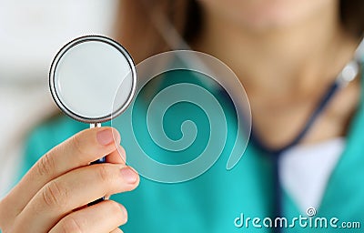 Young female medicine doctor holding stethoscope head Stock Photo