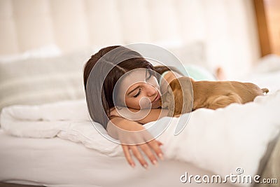 Female owner sleep with puppy pet Stock Photo