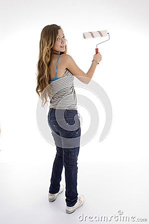 Young female painter with roller brush Stock Photo