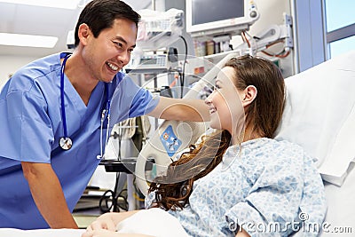 Young Female Patient Talking To Male Nurse In Emergency Room Stock Photo