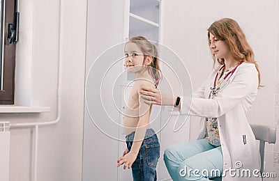 A young female pediatrician examines a girl in the office. Consultations. Diagnosis Stock Photo
