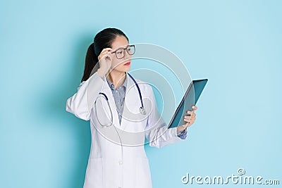 Young female physician checking tablet Stock Photo