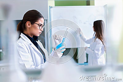 Young female researchers conducting laboratory test Stock Photo