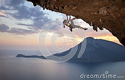 Young female rock climber at sunset Stock Photo