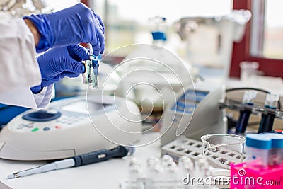 Young female scientist works in modern chemistry/biology lab Stock Photo