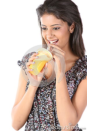 Young female sipping orange juice Stock Photo