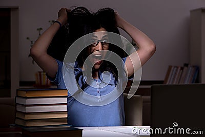 The young female student preparing for exams at night time Stock Photo