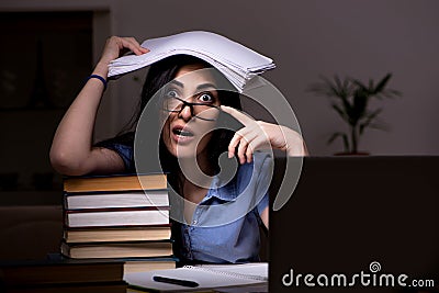 The young female student preparing for exams at night time Stock Photo