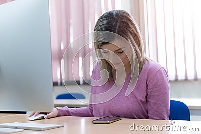 Young female student spending her time during lecture inside classroom in an international university Stock Photo