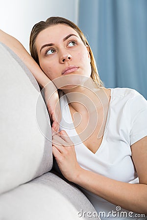 Young female is thoughtful and bored alone Stock Photo